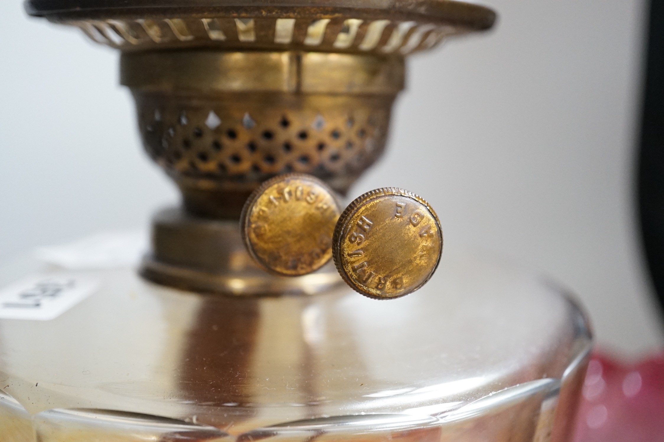 A Victorian brass and cranberry glass oil lamp
